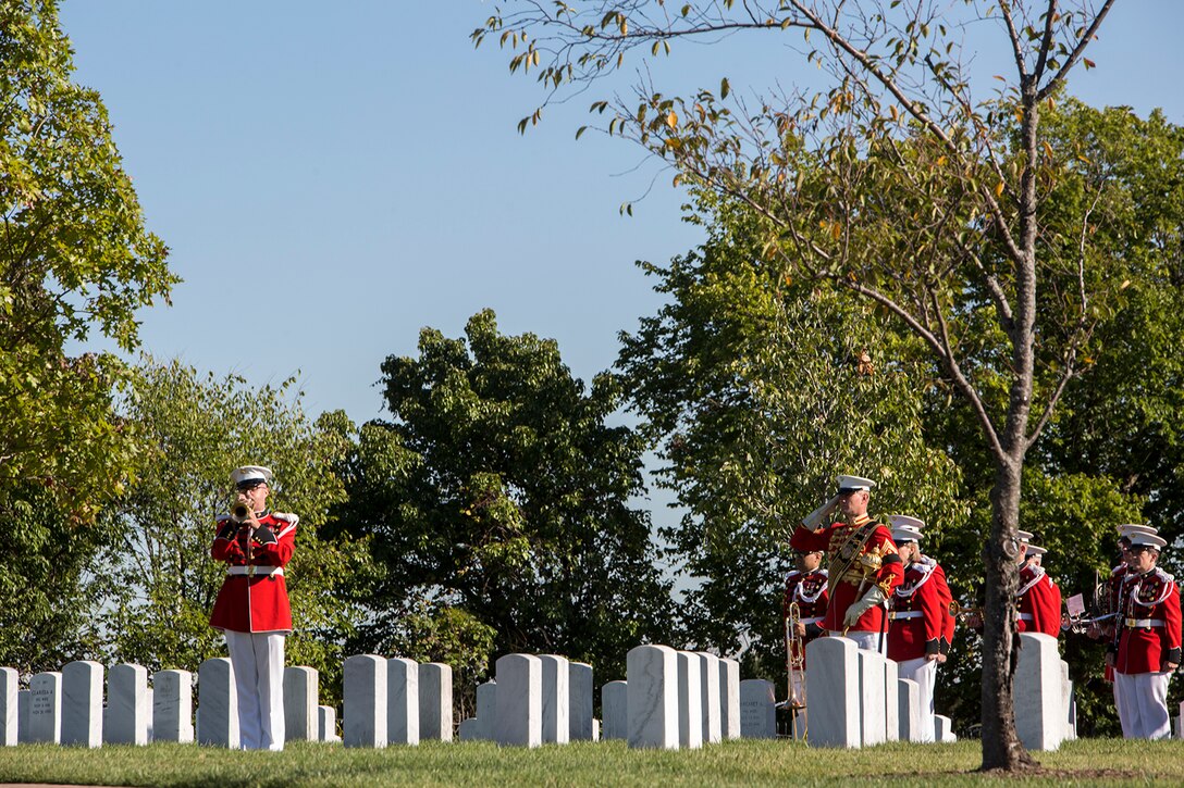 A Marine with “The President’s Own” Marine Band, Marine Barracks Washington D.C., plays taps during a full honors funeral at Arlington National Cemetery, Arlington, Va., Oct. 17, 2017. Marine Barracks Washington is home to the Marines who provide support for all Marine Corps funerals and many high-ranking government officials’ funerals within the National Capitol Region. (Official U.S. Marine Corps photo by Cpl. Robert Knapp/Released)