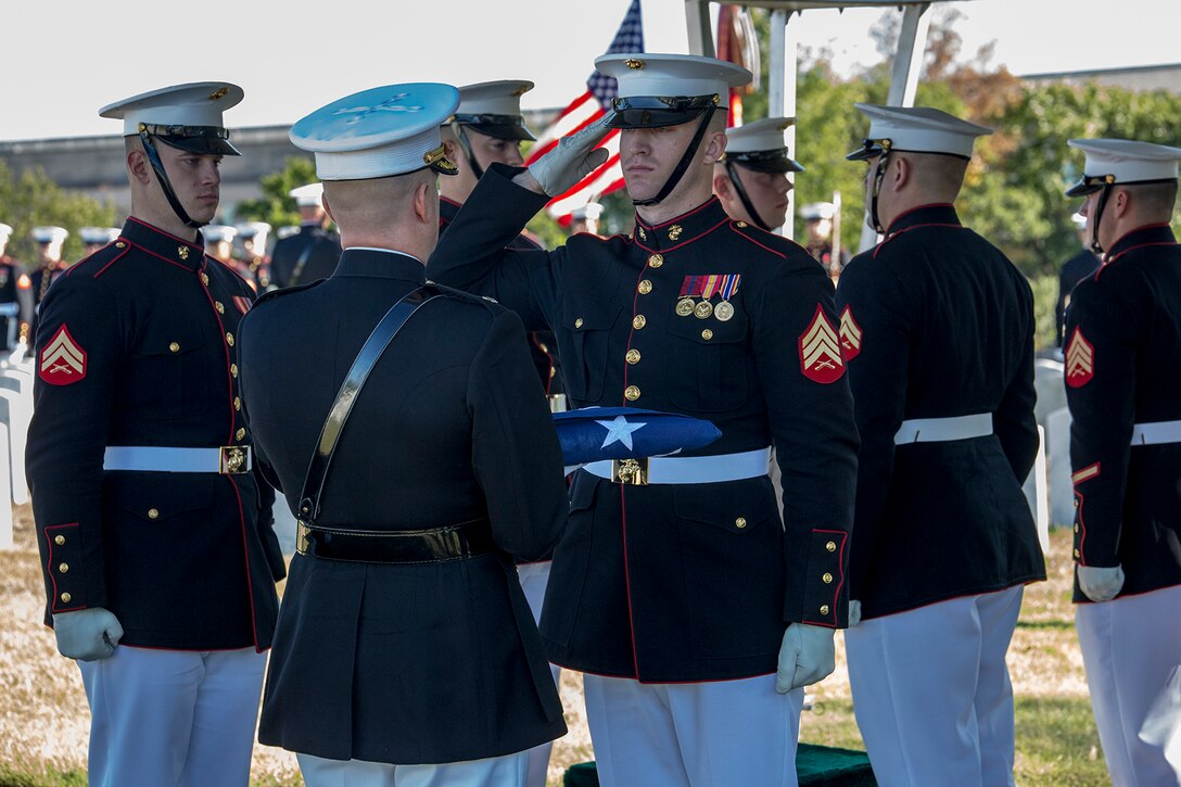 Sergeant Aaron P. Lindloff, Marine Corps Body Bearer, Marine Barracks Washington D.C., renders a salute to the National Ensign during a full honors funeral at Arlington National Cemetery, Arlington, Va., Oct. 17, 2017. Marine Barracks Washington is home to the Marines who provide support for all Marine Corps funerals and many high-ranking government officials’ funerals within the National Capitol Region. (Official U.S. Marine Corps photo by Cpl. Robert Knapp/Released)