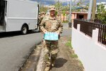 Lt. Gen. Jeffrey Buchanan, U.S. Army North commander, along with members of the Puerto Rico Army National Guard, Reserve and active duty, and Brig. Gen. José Reyes, Dual Status commander; and Caguas Mayor Hon. William Miranda Torres, distributed food and water to residents of the neighborhood Borinquen, Oct. 14. Reyes, Buchanan and Marín handed over provisions to the people who were grateful for the help received and were seriously affected by Hurricane Maria.