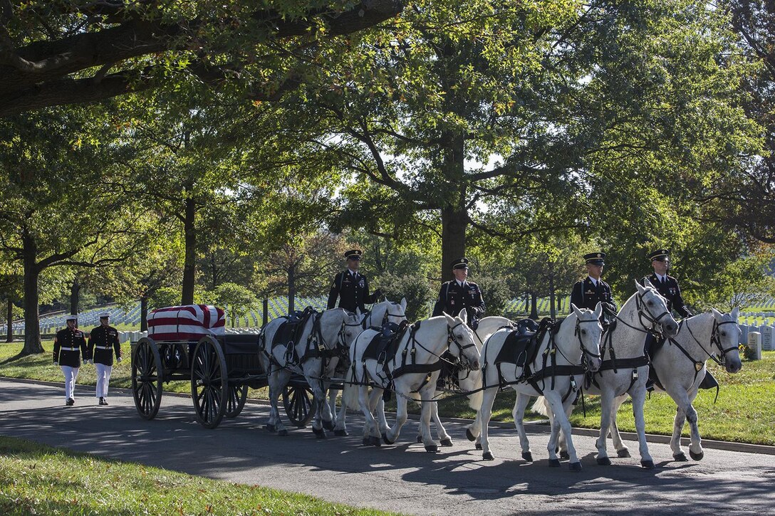 Marine Corps Body Bearers, Bravo Company, Marine Barracks Washington D.C., march behind members of the Caisson Platoon during a full honors funeral at Arlington National Cemetery, Arlington, Va., Oct. 17, 2017. Marine Barracks Washington is home to the Marines who provide support for all Marine Corps funerals and many high-ranking government officials’ funerals within the National Capitol Region. (Official U.S. Marine Corps photo by Cpl. Robert Knapp/Released)