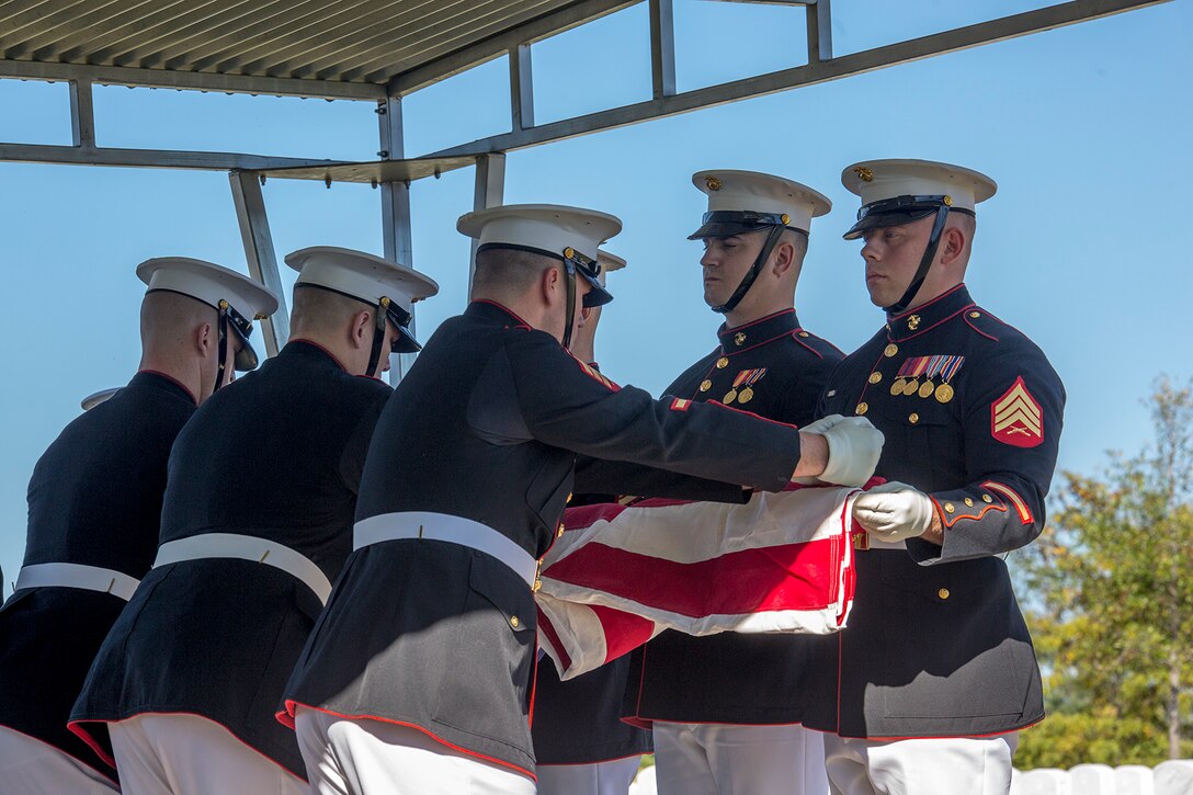 Marine Corps Body Bearers, Bravo Company, Marine Barracks Washington D.C., fold the National Ensign during a full honors funeral at Arlington National Cemetery, Arlington, Va., Oct. 17, 2017. Marine Barracks Washington is home to the Marines who provide support for all Marine Corps funerals and many high-ranking government officials’ funerals within the National Capitol Region. (Official U.S. Marine Corps photo by Cpl. Robert Knapp/Released)