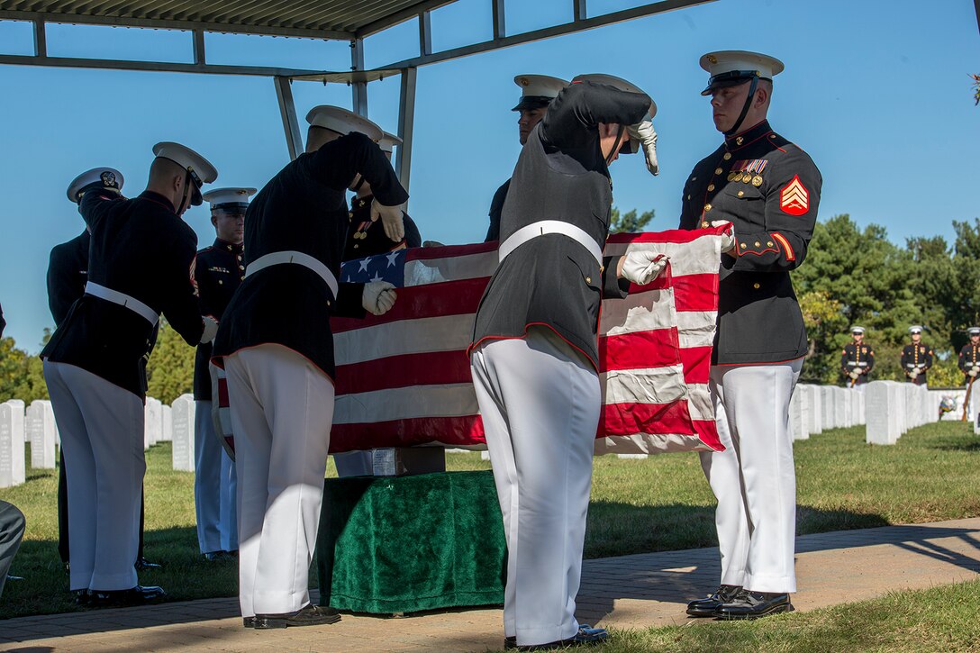 Marine Corps Body Bearers, Bravo Company, Marine Barracks Washington D.C., fold the National Ensign during a full honors funeral at Arlington National Cemetery, Arlington, Va., Oct. 17, 2017. Marine Barracks Washington is home to the Marines who provide support for all Marine Corps funerals and many high-ranking government officials’ funerals within the National Capitol Region. (Official U.S. Marine Corps photo by Cpl. Robert Knapp/Released)