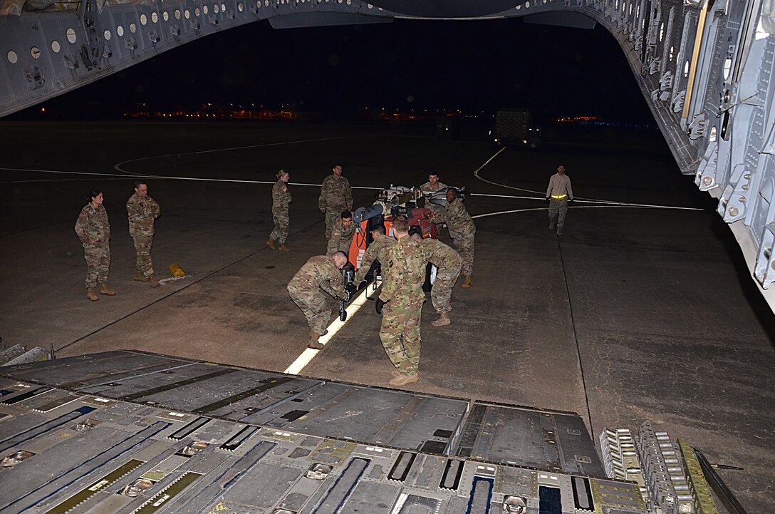 U.S. Army Soldiers assigned to the 832nd Transportation Battalion, 597th Transportation Brigade, work together to load equipment onto a U.S. Air Force Air Mobility Command C-17 at Joint Base Langley-Eustis, Va., Oct. 18, 2017.