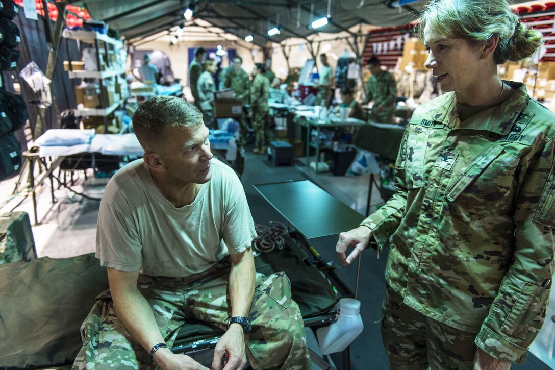 Army North commander talks with junior soldier.