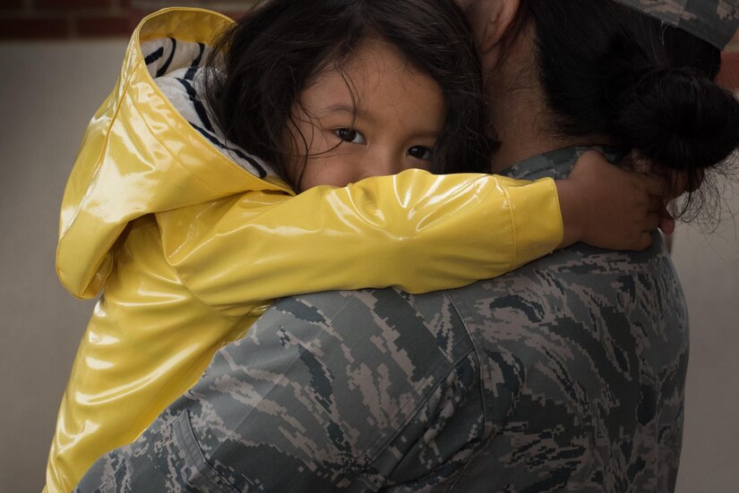 U.S. Air Force Maj. Becky Azama, 633rd Medical Operations Squadron physical medicine flight commander, embraces her daughter, Remi, before deploying from Joint Base Langley-Eustis, Va., Oct. 18, 2017.