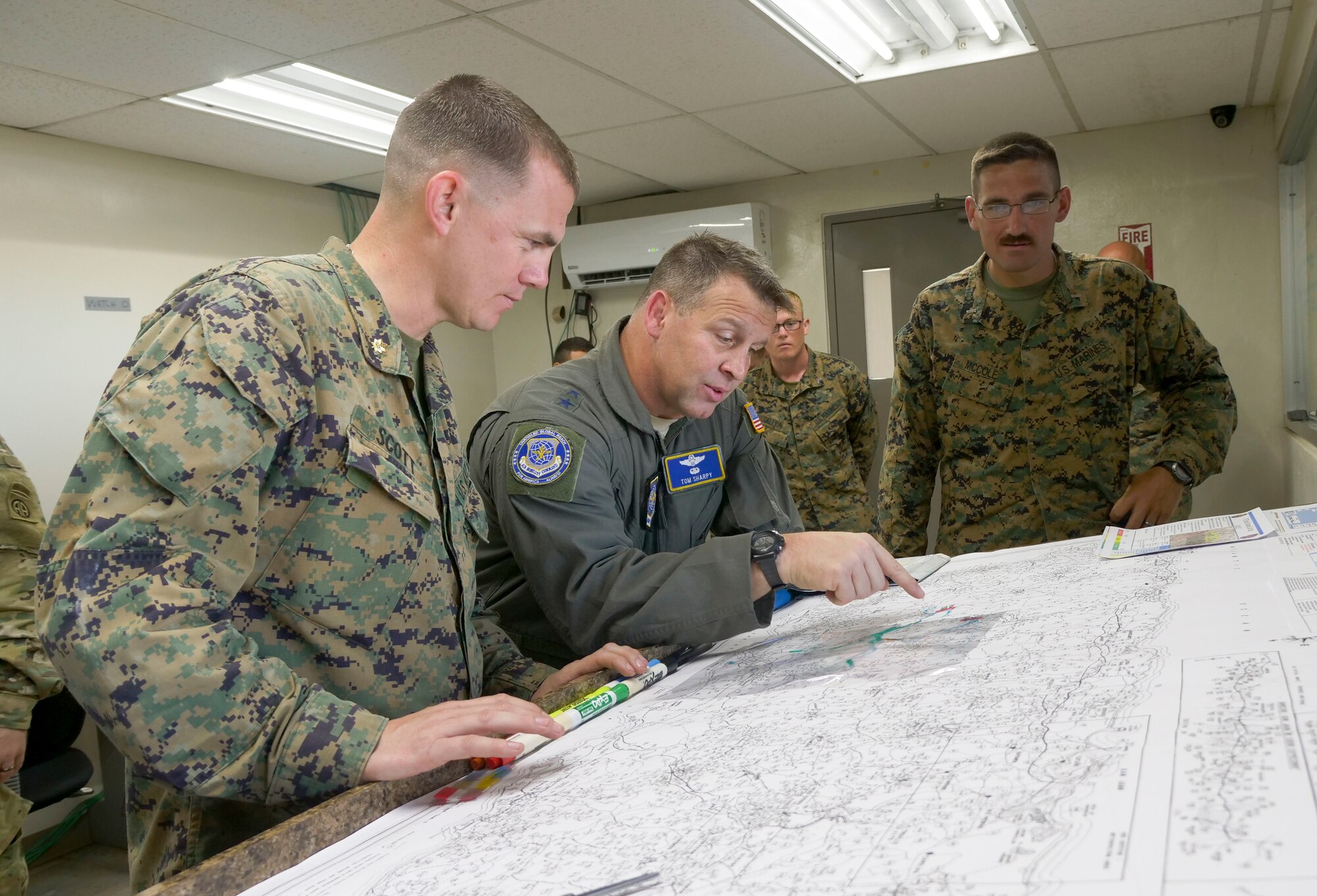 U.S Marine Corps Maj. Gregory Scott (left), 26th Marine Expeditionary Unit operations officer, briefs U.S. Air Force Maj. Gen. Timothy Sharpy, Joint Forces Land Component Commander deputy commander in charge of air operations, about operations in and around Mercedita Airport in Ponce, Puerto Rico, Oct. 8, 2017.