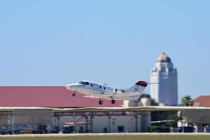 A T-1A Jayhawk takes off for a 99th Flying Training Squadron pilot instructor training mission Oct. 17, 2017 at Joint Base San Antonio-Randolph.  The domed building in the background is the iconic headquarters for the 12th Flying Training Wing known as the Taj Mahal. The "Taj" was built in 1931 and conceals a water tower. Ripples in the photo are from heat on the runway and engine exhaust. (U.S. Air Force photo by Randy Martin)
