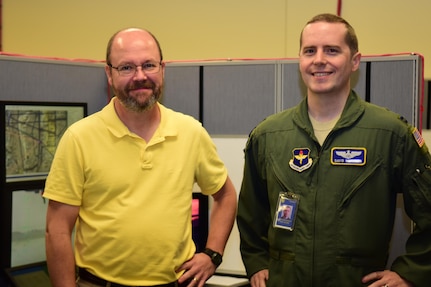 Remotely Piloted Aircraft Fundamentals Course Instructors Mark and Capt. David of the 558th Flying Training Squadron pose for a photo inside the Predator Reaper Integrated Mission Environment training room Oct. 18, 2017 at Joint Base San Antonio-Randolph.  PRIME allows RPA pilots and sensor operators to train together ahead of their training on a major weapon system.  Surnames were withheld according to Air Force guidelines on RPA operators and their identifying information.  (U.S. Air Force photo illustration by Randy Martin)