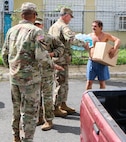 Members of the Puerto Rico Army National Guard, Reserve and active duty, along with Lt. Gen. Jeffrey Buchanan, U.S. Army North commander; Brig. Gen. José Reyes, Dual Status commander; and Caguas Mayor Hon. William Miranda Torres, distributed food and water to residents of the neighborhood Borinquen, Oct. 14. Reyes, Buchanan and Marín handed over provisions to the people who were grateful for the help received and were seriously affected by Hurricane Maria.