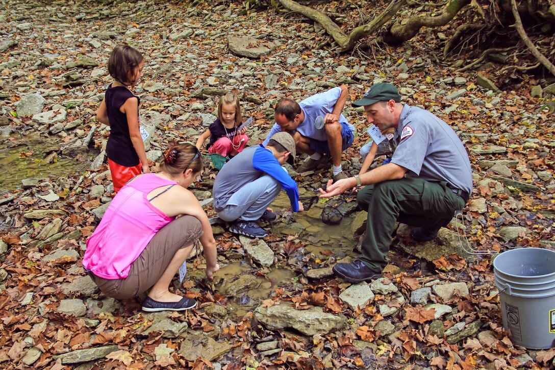 Ranger Mike Perrin and citizen scientists explore the macro-invertebrates found in the Sandy Run Creek below the dam at Caesar Creek Lake, Waynesville, Ohio.
