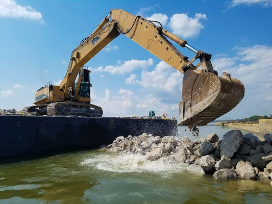 The Corps has built a rock dike, which will protect divers as they replace wickets in Dam 52.