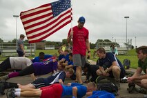 Participants in a ruck march challenge receive mentorship from their cadre while performing push-ups at Laughlin Air Force Base, Texas, Oct. 14, 2017.  The ruck was a 10-kilometer march which contained various challenges along the course. (U.S. Air Force photo\Airman 1st Class Daniel Hambor)