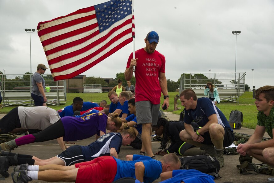Participants in a ruck march challenge receive mentorship from their cadre while performing push-ups at Laughlin Air Force Base, Texas, Oct. 14, 2017.  The ruck was a 10-kilometer march which contained various challenges along the course. (U.S. Air Force photo\Airman 1st Class Daniel Hambor)