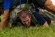 Participants in a ruck march challenge low crawl under their team at Laughlin Air Force Base, Texas, Oct. 14, 2017.  The march started when the 23-person group finished a series of team-building exercises consisting of low crawls, crowd surfing, and bear crawls.  (U.S. Air Force photo\Airman 1st Class Daniel Hambor)