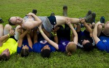 Participants in a ruck march challenge perform a crowd surfing exercise at Laughlin Air Force Base, Texas, Oct. 14, 2017.  The ruck, which started at Laughlin’s football field and continued throughout the base, was a 10-kilometer march which contained various challenges at various points along the route. (U.S. Air Force photo\Airman 1st Class Daniel Hambor)