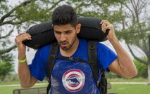 Participants in a ruck march challenge carries a newly filled sand bag at Laughlin Air Force Base, Texas, Oct. 14, 2017.  The march stopped at various points along the trail to either complete a challenge, or to add more weight to their packs. (U.S. Air Force photo\Airman 1st Class Daniel Hambor)