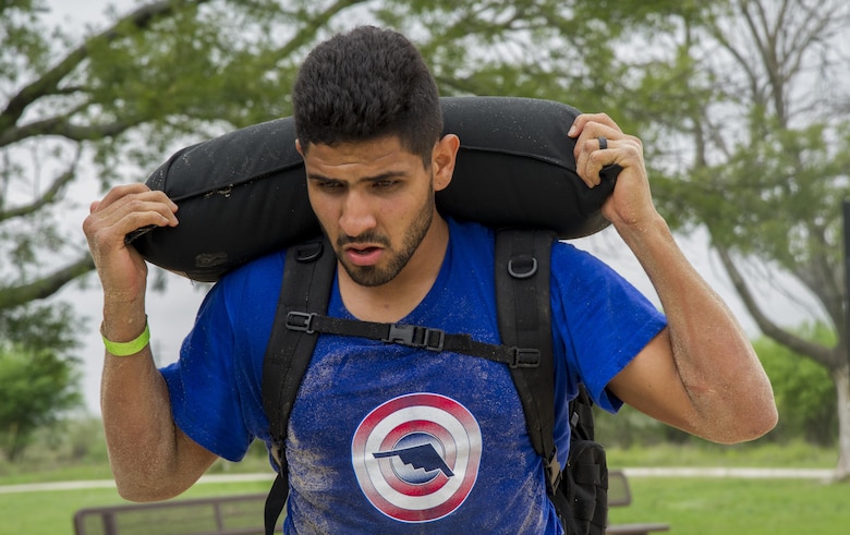 Participants in a ruck march challenge carries a newly filled sand bag at Laughlin Air Force Base, Texas, Oct. 14, 2017.  The march stopped at various points along the trail to either complete a challenge, or to add more weight to their packs. (U.S. Air Force photo\Airman 1st Class Daniel Hambor)