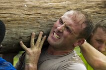 Participants in a ruck march challenge lift a log at Laughlin Air Force Base, Texas, Oct. 14, 2017.  The ruck, which challenged the 23-person team at various points during the 10 kilometer march, consisted of many team cohesion challenges. (U.S. Air Force photo\Airman 1st Class Daniel Hambor)