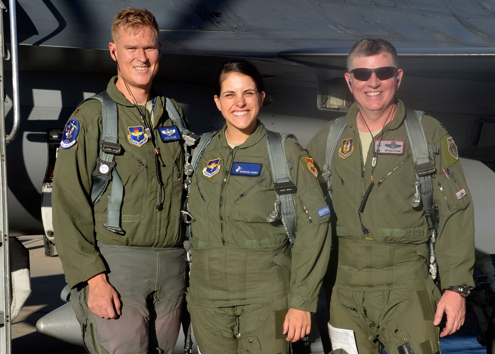 Maj. Alex Divine, 309th Fighter Squadron pilot, and Maj. Barbara Divine, 56th Contracting Squadron commander, take a photo with Col. Bryan Cook, 944th Fighter Wing commander, after their F-16 formation flight at Luke Air Force Base, Ariz., Oct. 12, 2017. Maj. Barbara Divine learned firsthand what her husband goes through in his training sorties and how her career in contracting impacts the mission. (U.S. Air Force photo by Senior Airman Devante Williams)