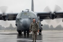 Chief Master Sgt. Eric Evers, 374th Aircraft Maintenance Squadron superintendent, walks on a ramp as he marshals a C-130H Hercules at Yokota Air Base, Japan, Oct. 16, 2017.