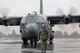 Chief Master Sgt. Eric Evers, 374th Aircraft Maintenance Squadron superintendent, walks on a ramp as he marshals a C-130H Hercules at Yokota Air Base, Japan, Oct. 16, 2017.