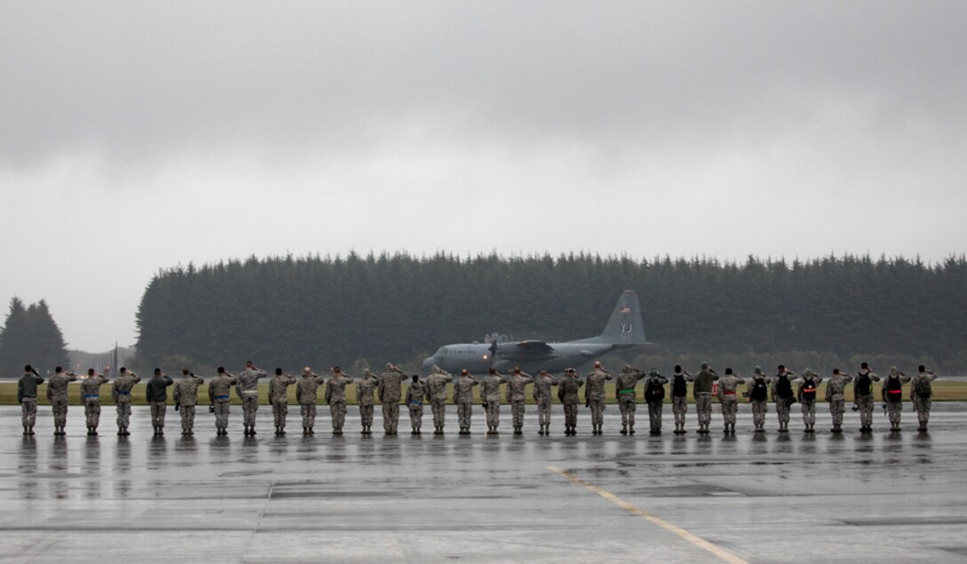 Members with the 374th Aircraft Maintenance Squadron salute the last C-130H Hercules departing from Yokota Air Base, Japan, Oct. 16, 2017.