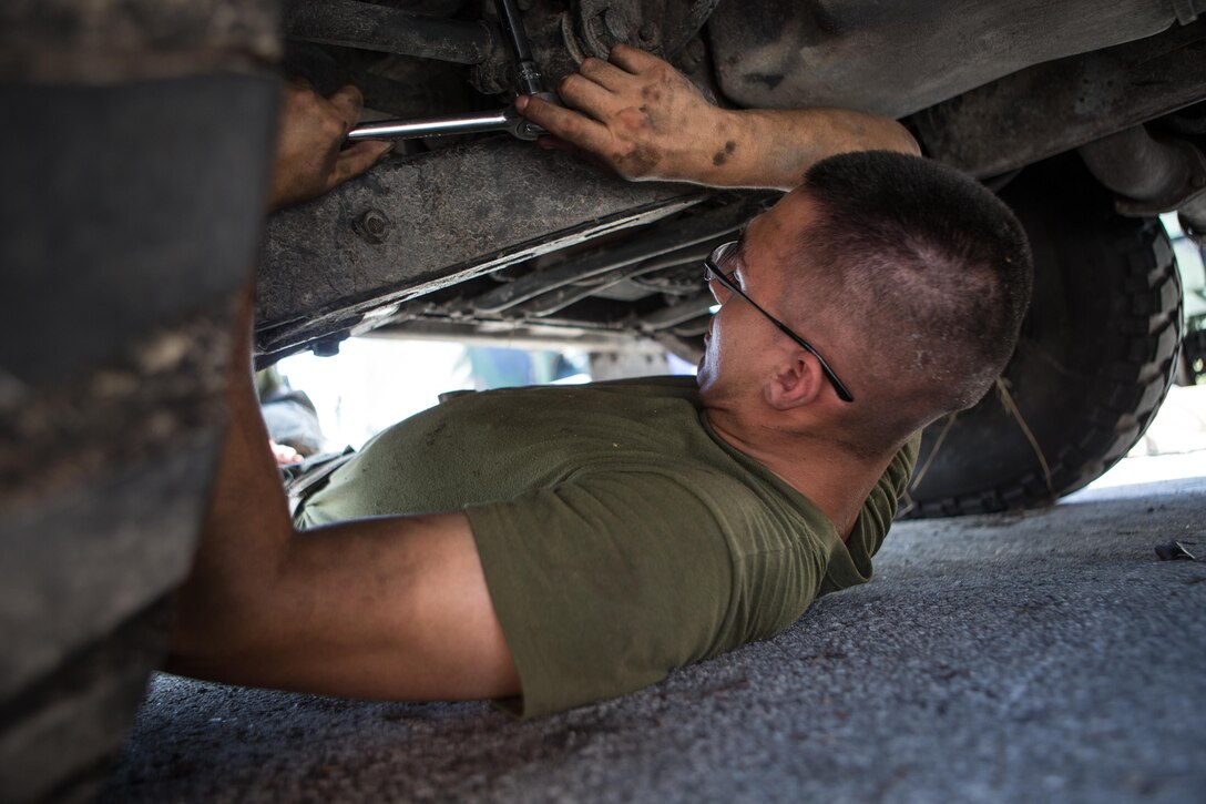 U.S Marine Corps Pfc. Carlos J. Deleon, an antitank missile gunner with Battalion Landing Team 2nd Battalion, 6th Marine Regiment, tightens a bolt while installing a system on a high-mobility, multipurpose wheeled vehicle (HMMWV) at Camp Lejeune, N.C., Oct. 3, 2017.