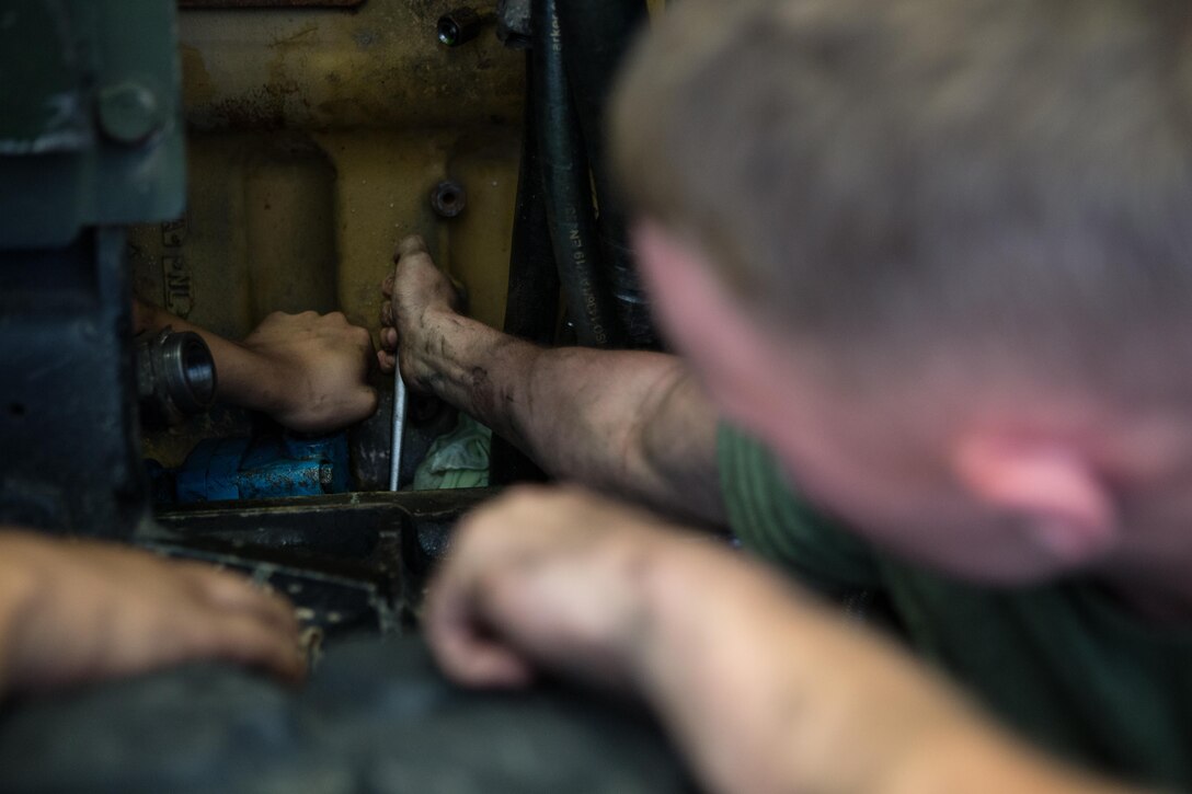 U.S. Marine Corps Cpl. Jeremy L. Rackley, an automotive maintenance technician with Combat Logistics Battalion 26, tightens a bolt on a Medium Tactical Vehicle Replacement (MTVR) at Camp Lejeune, N.C., Oct. 3, 2017.