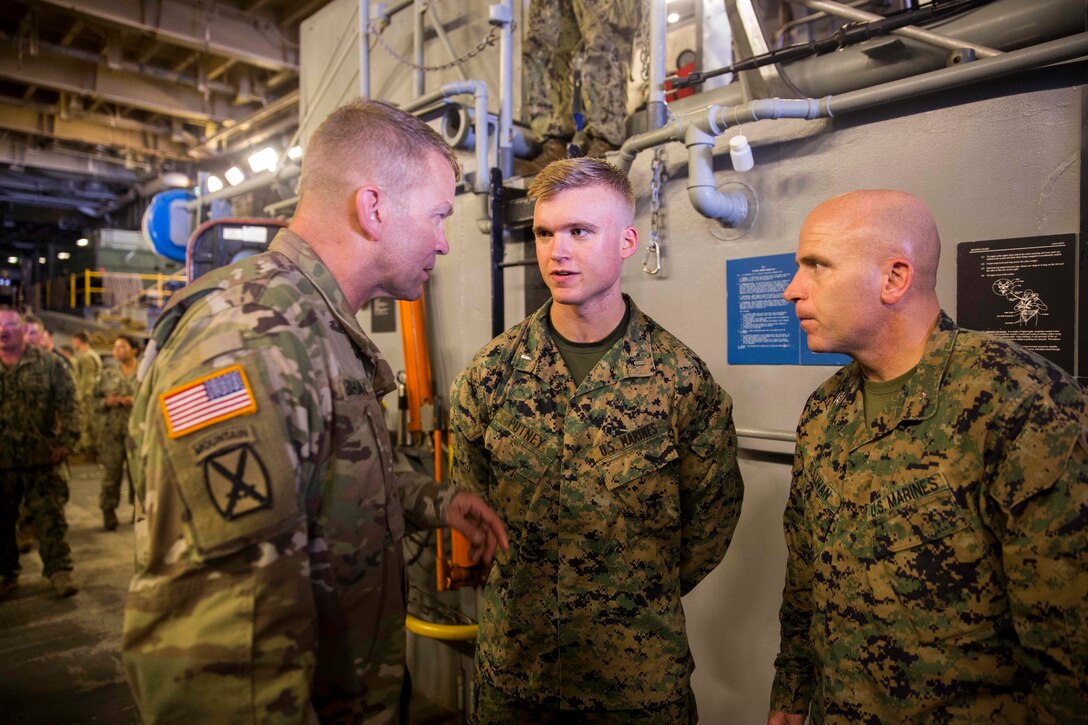 U.S. Army Lt. Gen. Jeffrey Buchanan, left, the Commander of U.S. Army North, speaks to U.S. Marine Corps 1st Lt. Michael Putney, center, an intelligence officer with Battalion Landing Team 2nd Battalion, 6th Marine Regiment, 26th Marine Expeditionary Unit (MEU) about his experience while providing hurricane relief to Puerto Rico aboard the amphibious assault ship USS Kearsarge  ( LHD 3) in the Caribbean Sea, Oct. 14, 2017.