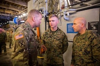 U.S. Army Lt. Gen. Jeffrey Buchanan, left, the Commander of U.S. Army North, speaks to U.S. Marine Corps 1st Lt. Michael Putney, center, an intelligence officer with Battalion Landing Team 2nd Battalion, 6th Marine Regiment, 26th Marine Expeditionary Unit (MEU) about his experience while providing hurricane relief to Puerto Rico aboard the amphibious assault ship USS Kearsarge  ( LHD 3) in the Caribbean Sea, Oct. 14, 2017.
