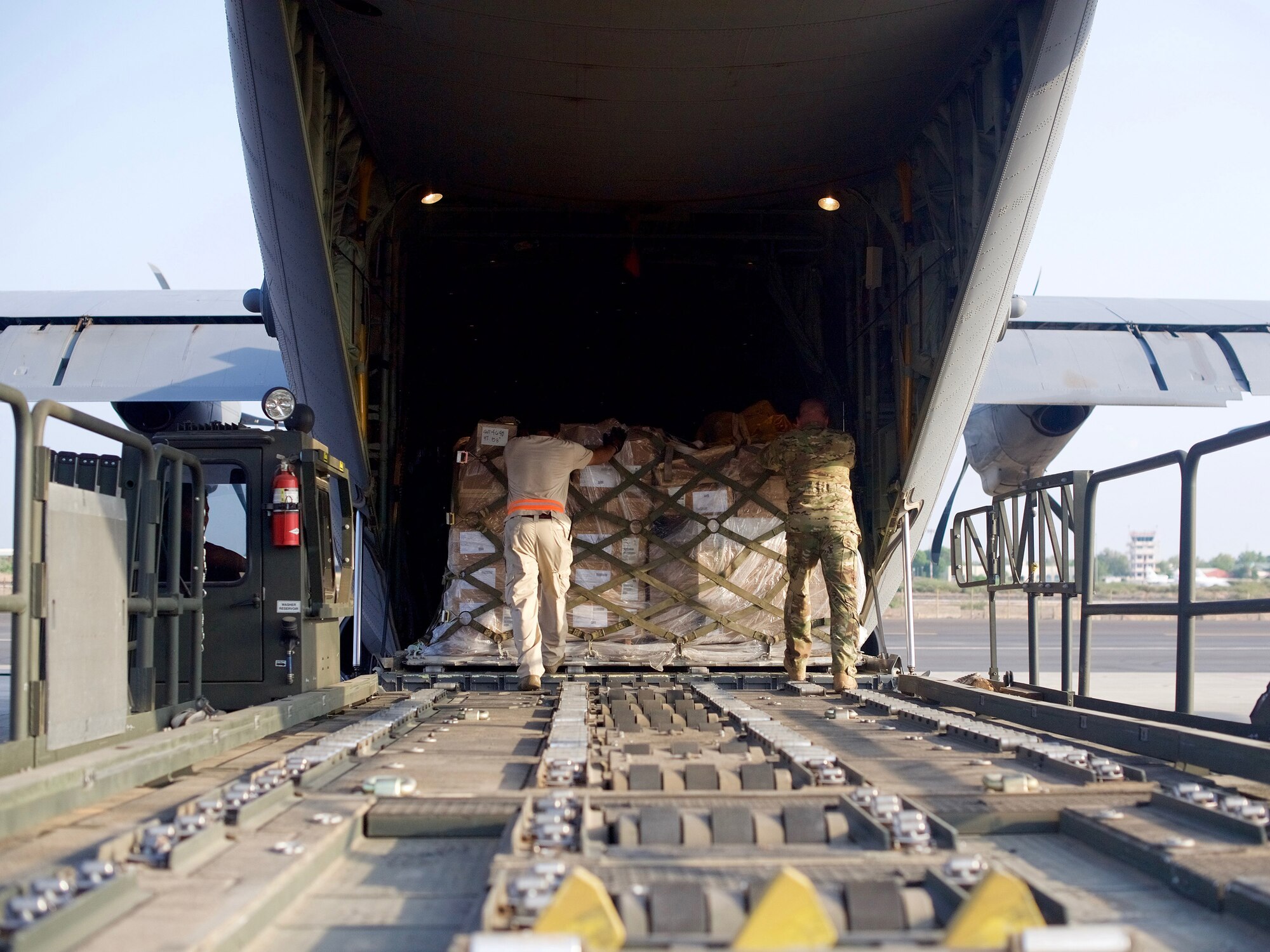 U.S. Airmen from the 449th Air Expeditionary Group load pallets of medical and humanitarian aid supplies onto a U.S. C-130J Super Hercules at Camp Lemonnier, Djibouti, Oct. 17, 2017.