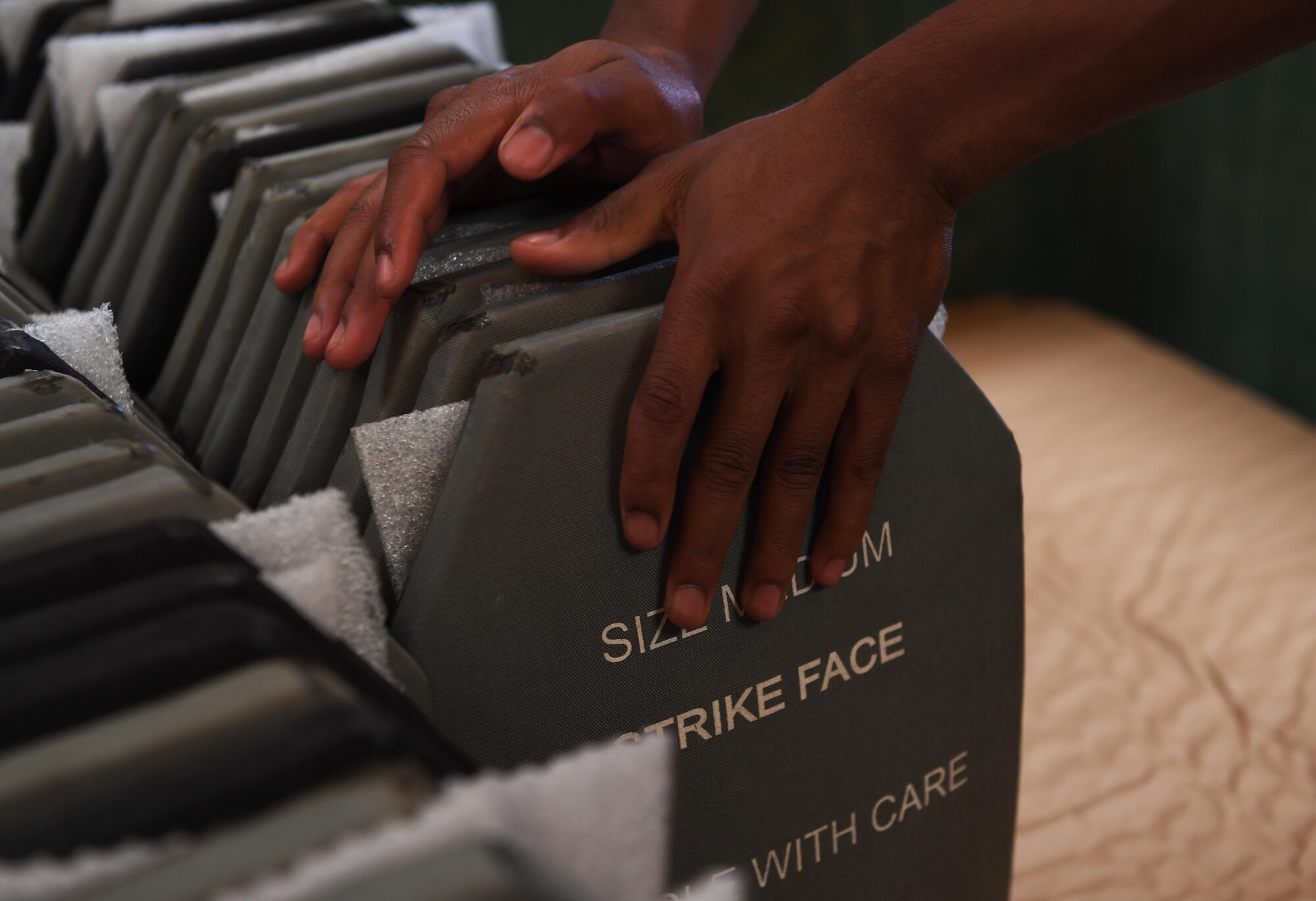 U.S. Air Force Senior Airman Tyler Trabue, aircraft parts store journeyman assigned to 447th Air Expeditionary Group, stacks improved outer tactical vest (IOTV) plates at Incirlik Air Base, Turkey, Sept. 25, 2017.  APS Airmen inspect all IOTV plates before initial issue to ensure there is no damage. (U.S. Air Force photo by Senior Airman Jasmonet D. Jackson)