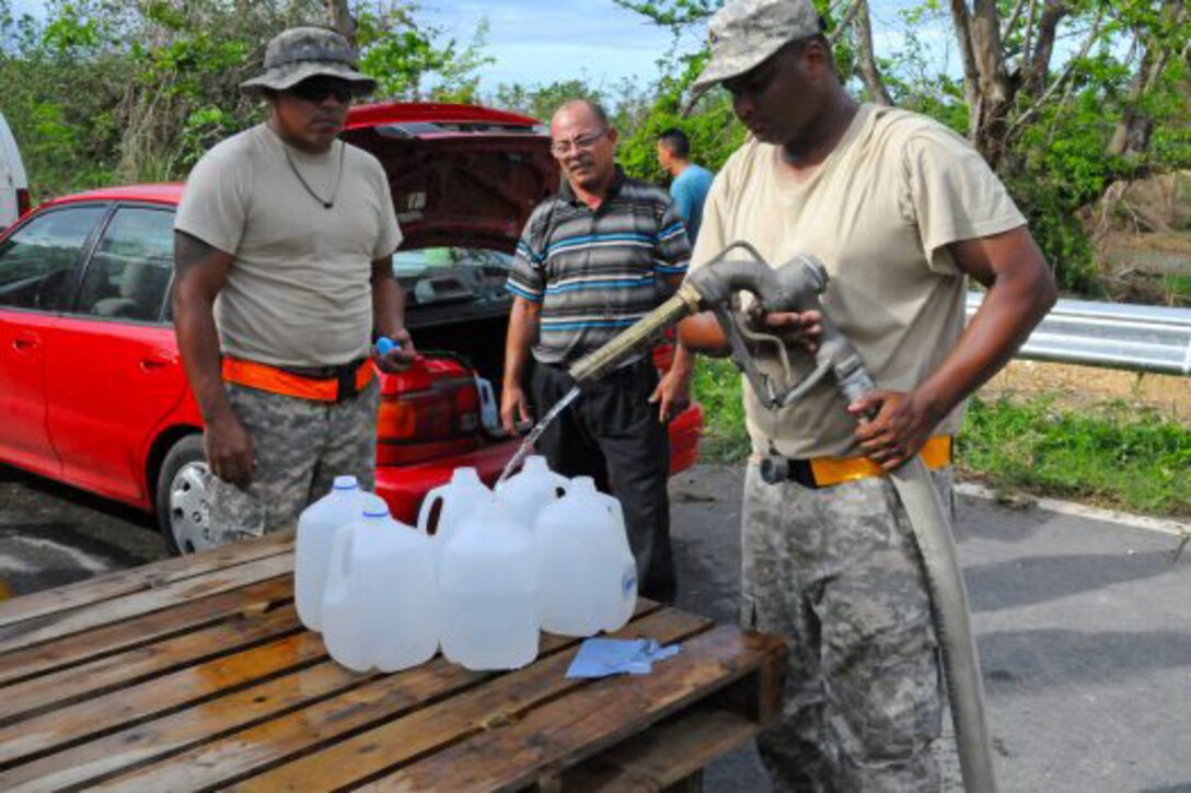Soldiers provide potable water for a resident of Puerto Rico.