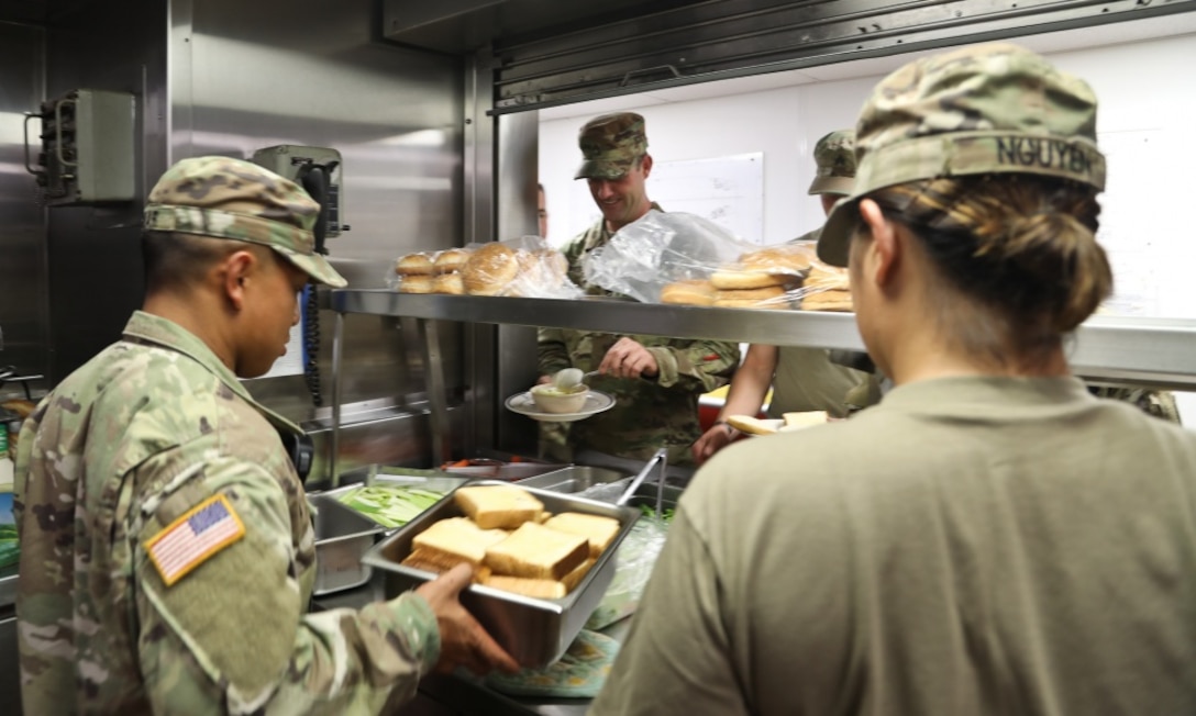 Army Sgt. James Munar, a Pomona, Calif., native and a culinary specialist with the 605th Transportation Detachment, 8th Special Troops Battalion, 8th Theater Sustainment Command, helps prepare lunch with his soldiers on the logistic support vessel, the USAV CW3 Harold A. Clinger, off the Hawaiian coast, Oct. 4, 2017. Army photo by Staff Sgt. Melissa Parrish