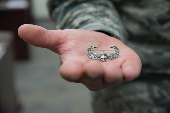 Senior Airman Jonathan Kling, 403rd Security Forces Squadron fire team member, shows off his new Air Assault badge along with his Security Forces badge after completing U.S. Army Air Assault School Sept. 26, 2017 at Keesler Air Force Base, Mississippi. (U.S. Air Force photo/Staff Sgt. Heather Heiney)