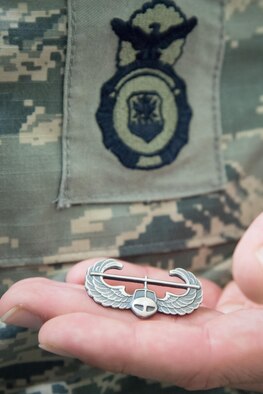 Senior Airman Jonathan Kling, 403rd Security Forces Squadron fire team member, shows off his new Air Assault badge along with his Security Forces badge after completing U.S. Army Air Assault School Sept. 26, 2017 at Keesler Air Force Base, Mississippi. (U.S. Air Force photo/Staff Sgt. Heather Heiney)