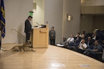 Marco Robledo, a disabled combat veteran and federal employee, speaks at Naval Surface Warfare Center, Carderock Division’s combined observance for National Hispanic Heritage Month and National Disability Employment Awareness Month in West Bethesda, Md., Oct. 12, 2017, with his service dog, Chuck Diesel. Robledo was wounded by an improvised explosive device while deployed to Iraq as a combat engineer with the National Guard in 2007. After he rehabilitated from his injuries, he followed a mentor’s advice and applied to work at Carderock as a contract specialist. He spoke about being grateful for his fellow Soldiers who saved his life and about overcoming his challenges and making a good life for himself following his upbringing by struggling migrant workers. (U.S. Navy photo by Dustin Q. Diaz/Released)