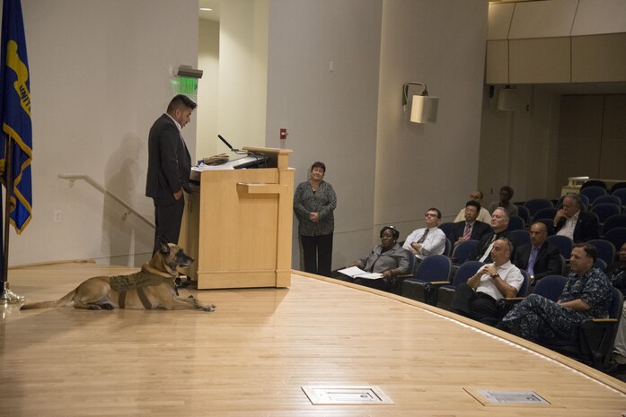 Marco Robledo, a disabled combat veteran and federal employee, speaks at Naval Surface Warfare Center, Carderock Division’s combined observance for National Hispanic Heritage Month and National Disability Employment Awareness Month in West Bethesda, Md., Oct. 12, 2017, with his service dog, Chuck Diesel. Robledo was wounded by an improvised explosive device while deployed to Iraq as a combat engineer with the National Guard in 2007. After he rehabilitated from his injuries, he followed a mentor’s advice and applied to work at Carderock as a contract specialist. He spoke about being grateful for his fellow Soldiers who saved his life and about overcoming his challenges and making a good life for himself following his upbringing by struggling migrant workers. (U.S. Navy photo by Dustin Q. Diaz/Released)