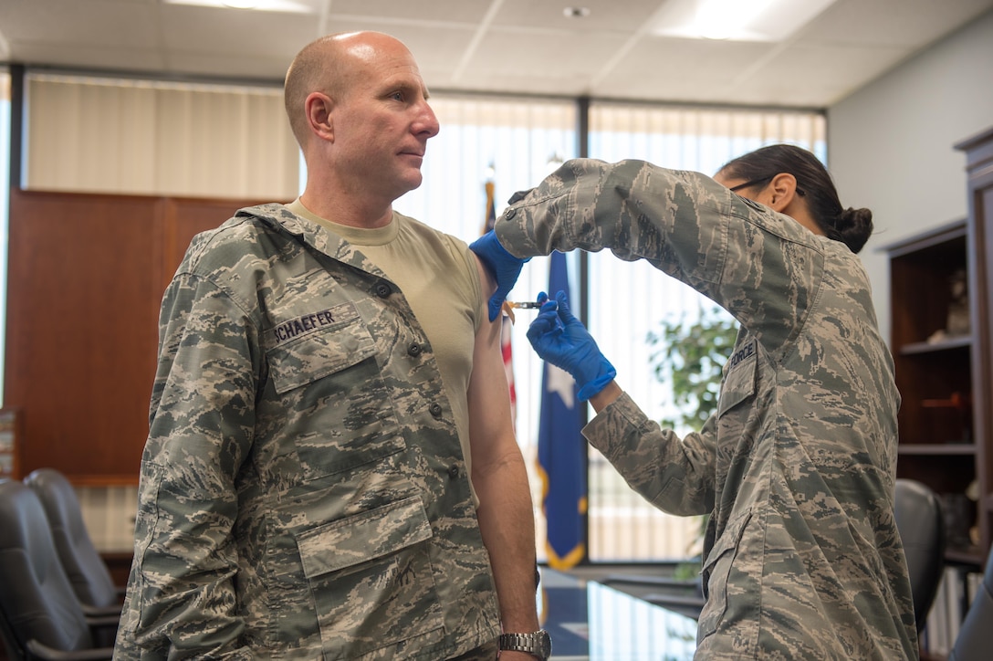 Brig. Gen. Carl Schaefer, 412th Test Wing commander, receives his annual flu shot from Staff Sgt. Moana Bailey, 412th Medical Operations Squadron, at test wing headquarters.