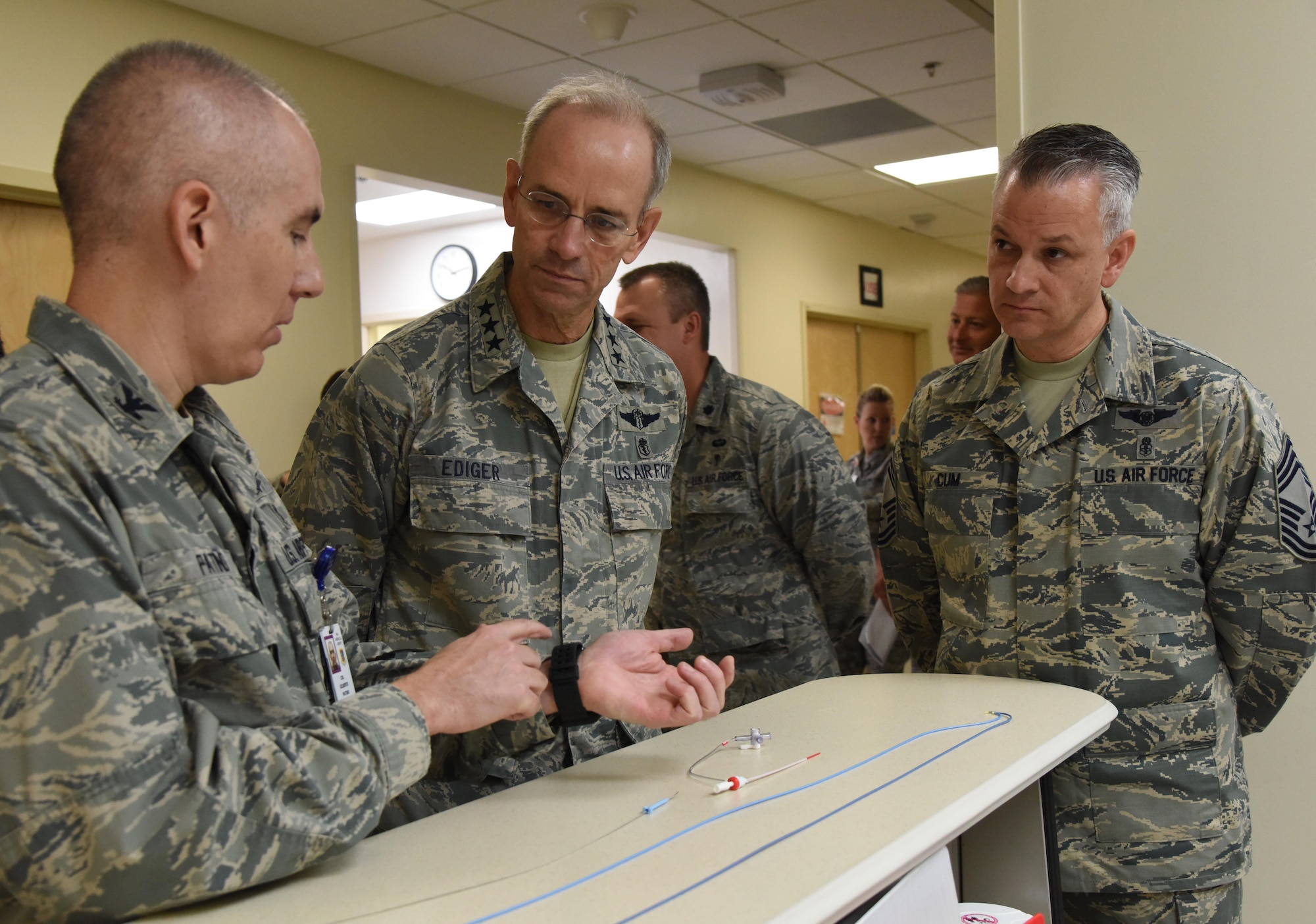 Col. Gilberto Patino, 81st Medical Operations Squadron cardiopulmonary flight commander, explains surgical procedures used in the cardiac catheterization lab to Lt. Gen. Mark Ediger, Air Force Surgeon General, and Chief Master Sgt. Steve Cum, Jr., Air Force Surgeon General medical enlisted force chief, during a visit to the 81st Medical Group Oct. 17, 2017, on Keesler Air Force Base, Mississippi. The purpose of Ediger’s visit was to get familiar with the 81st MDG’s mission, operations and personnel. During his tour, he visited more than 10 different units in the 81st MDG to include mammography, emergency department, radiology and oncology, genetics and the clinical research laboratory. (U.S. Air Force photo by Kemberly Groue)