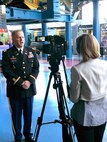 Lt. Col. Hugh Darville, Huntsville Center deputy commander, answers questions from WAFF reporter Stephanie Mills during the Small Business Forum at the Davidson Center for Space Exploration in Huntsville, Alabama, Oct. 18. The forum helps to identify government needs and business capabilities in order to meet the nation’s engineering challenges.