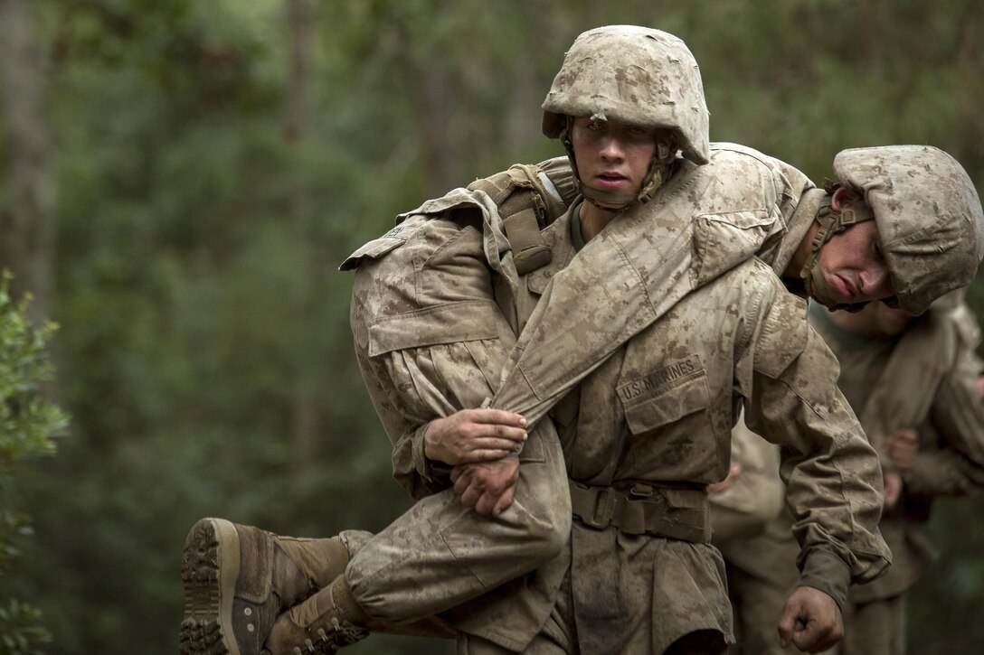 Marines practice carrying a simulated combat casualty.