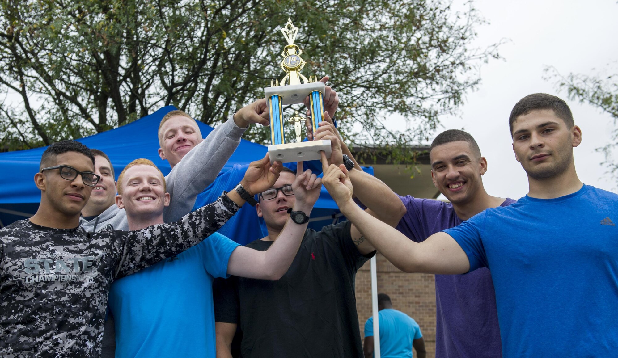 Airmen hold up trophy