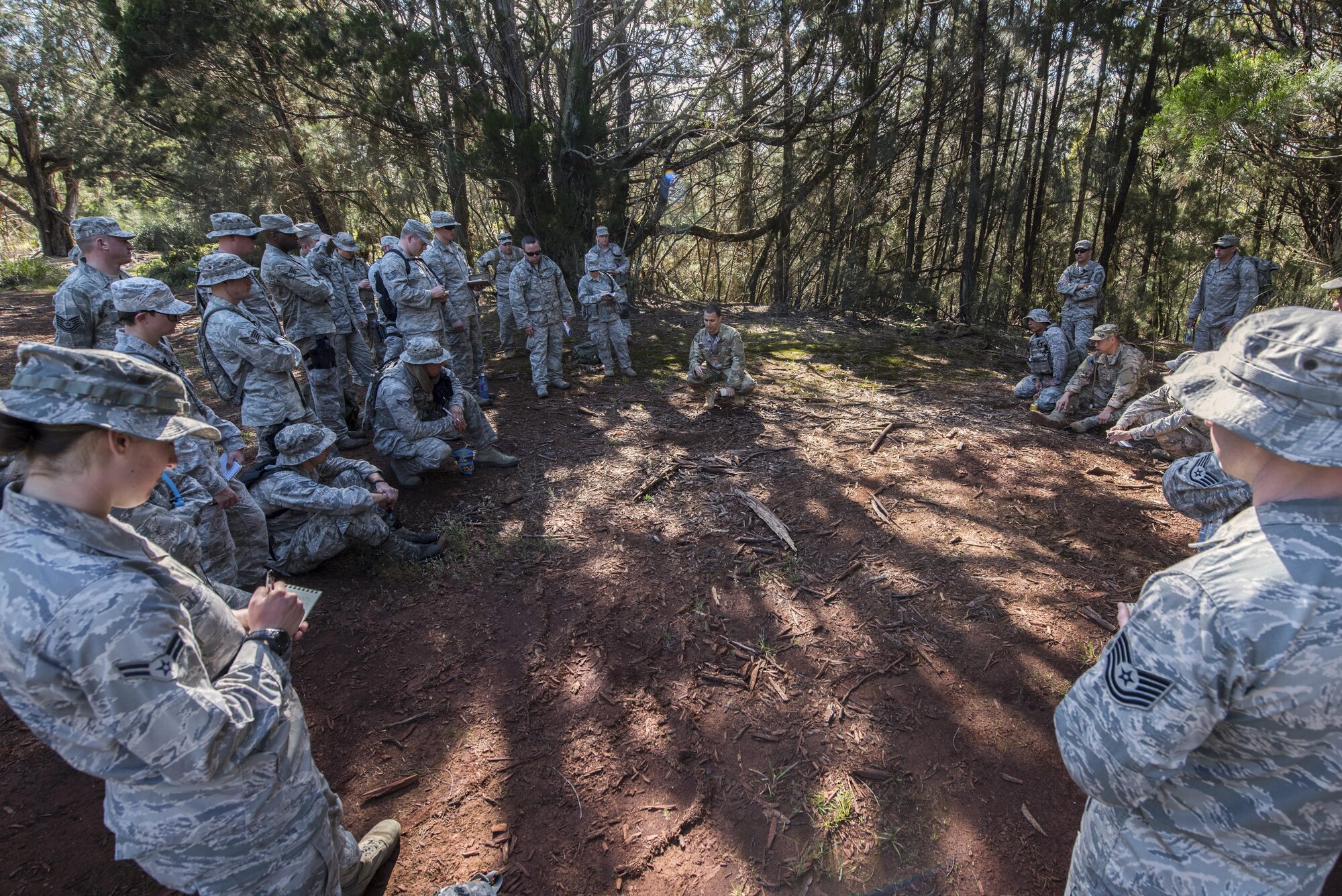 Security Forces Airmen from the 141st and 194th Security Forces Squadrons from Washington State watch as a jungle warfare training instructor demonstrates basic tracking techniques March 8, 2017, at a training site on Schofield Barracks, Hawaii. Airmen were taught to look for disturbed ground, broken branches and grass, or any other physical evidence that would suggest recent human activity. (U.S. Air National Guard photo by Staff Sgt. Rose Lust/Released)
