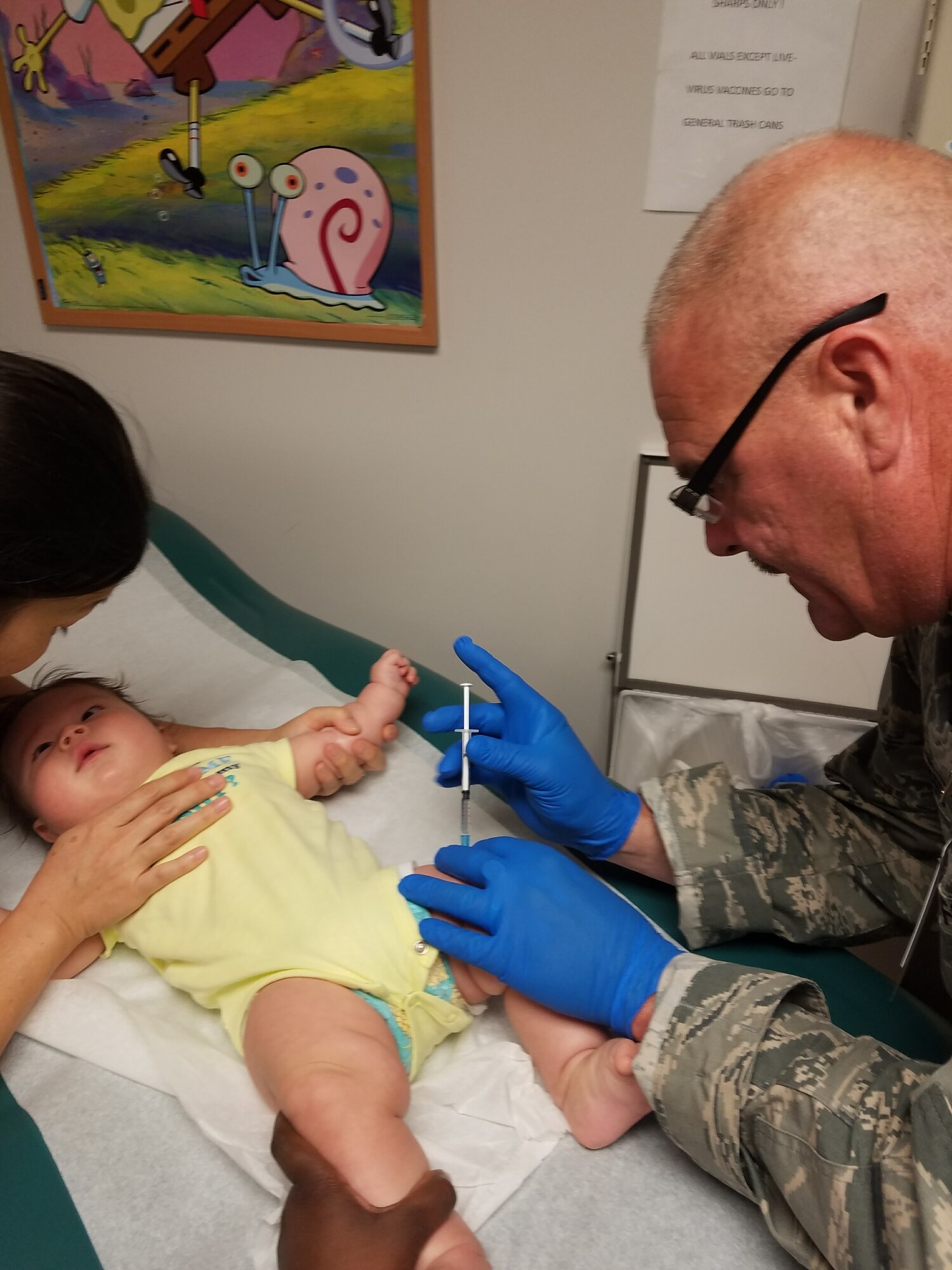 U.S. Air Force Technical Sgt. Philip Travers, a medical technician in the New York Air National Guard's 106th Rescue Wing, gives a shot to a child at Joint Base Pearl Harbor-Hickam in Hawaii Aug. 29, 2017. 106th Rescue Wing Medical Group members fanned out recently at Joint Base Pearl Harbor-Hickam in Hawaii to accomplish real-world training at premier medical facility, Tripler Army Medical Center (TAMC) and the 15th Medical Group.