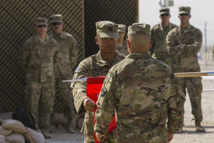 Army Capt. Luis Camacho Santiago and 1st Sgt. Jose Reyes case the colors of the Puerto Rico Army National Guard’s 215th Engineer Company during a transfer of authority ceremony at Camp Buehring, Kuwait.