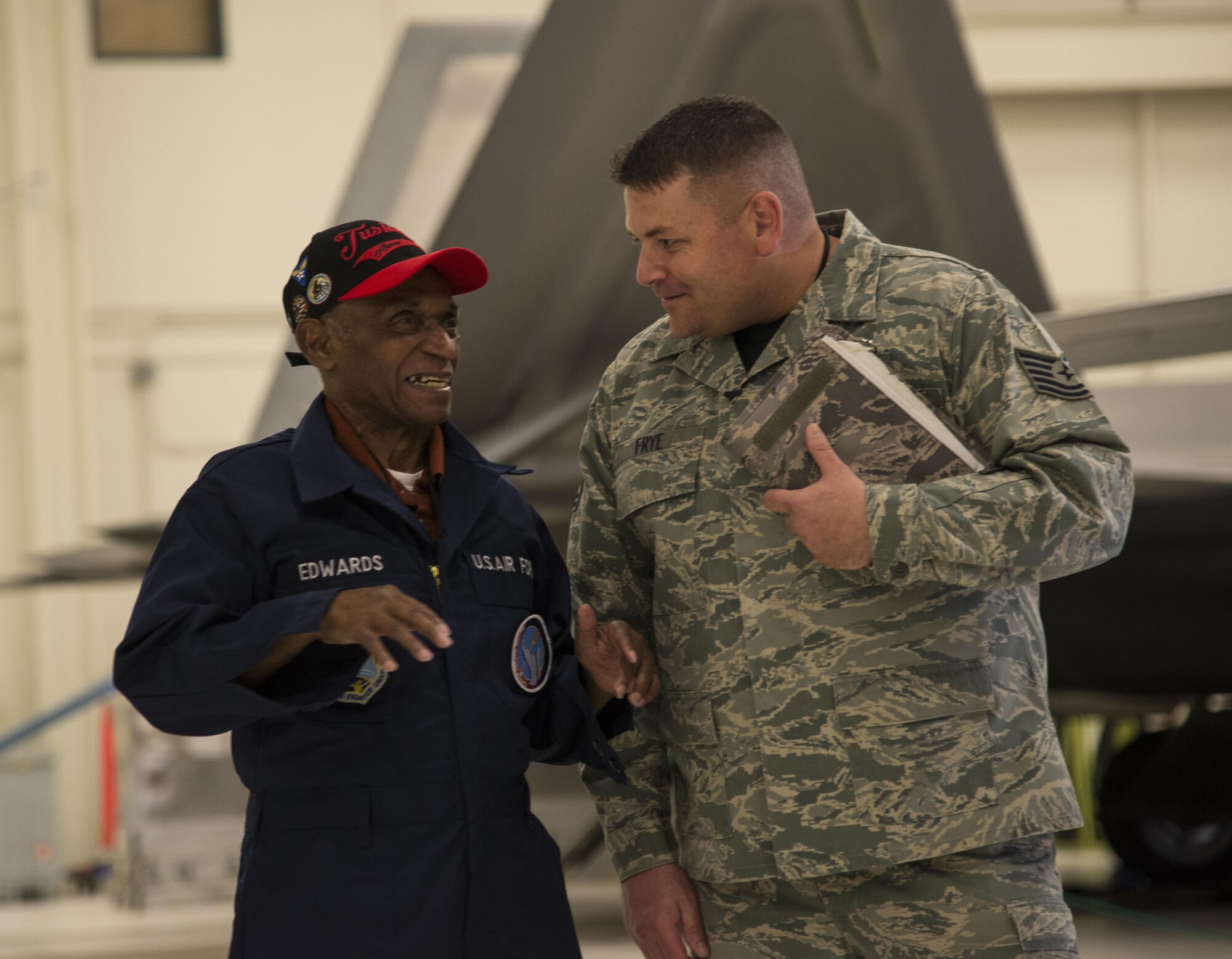 Army Air Corps Staff Sgt. Leslie Edwards, the last known living Tuskegee Airman of the the 477th Bombardment Group, meets U.S. Air Force Tech. Sgt. Jeremiah Frye, 477th Fighter Group quality assurance inspector, at Joint Base Elmendorf-Richardson, Alaska, Oct. 14, 2017. In 2007, the 477th Bombardment Group became the 477th Fighter Group, bringing with it the legacy of Tuskegee Airmen to Alaska. (U.S. Air Force photo by Senior Airman Curt Beach)