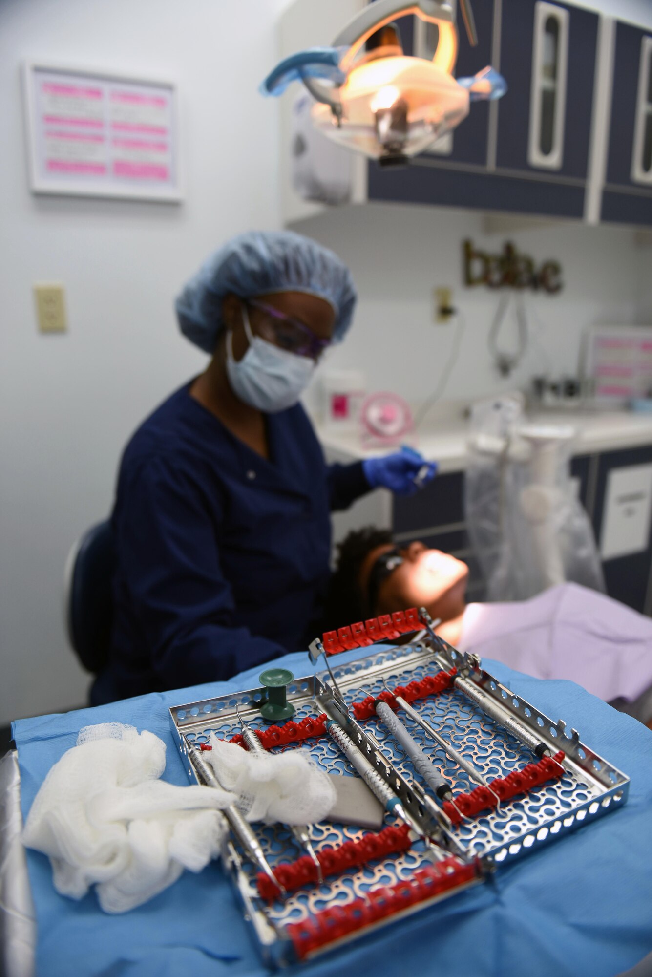 Tech. Sgt. Stephanie Janney, 344th Training Squadron NCOIC of information management, has her teeth cleaned by Aleshiea Johnson, 30th Medical Operations Squadron registered dental assistant, Oct. 18, 2017, Vandenberg Air Force Base, Calif. The dental flight, within the 30th MDOS, is currently celebrating October's National Dental Hygiene Month. The month aims to help raise public awareness on the topic of good oral health and focuses on three main components – brushing teeth daily, flossing, and smart nutrition. (U.S. Air Force photo by Senior Airman Kyla Gifford/Released)
