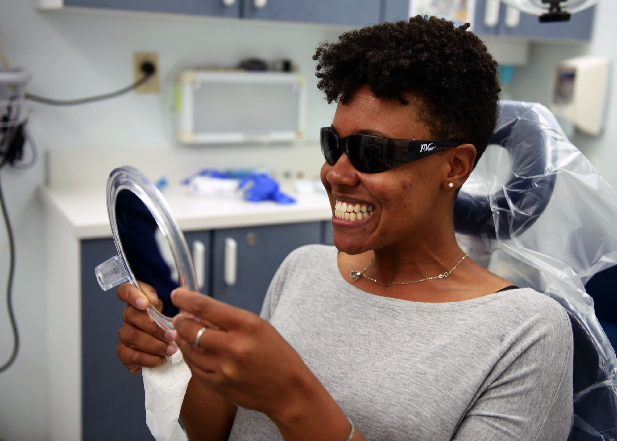 Tech. Sgt. Stephanie Janney, 344th Training Squadron NCOIC of information management, has her teeth cleaned by Aleshiea Johnson, 30th Medical Operations Squadron registered dental assistant, Oct. 18, 2017, Vandenberg Air Force Base, Calif. The dental flight, within the 30th MDOS, is currently celebrating October's National Dental Hygiene Month. The month aims to help raise public awareness on the topic of good oral health and focuses on three main components – brushing teeth daily, flossing, and smart nutrition. (U.S. Air Force photo by Senior Airman Kyla Gifford/Released)