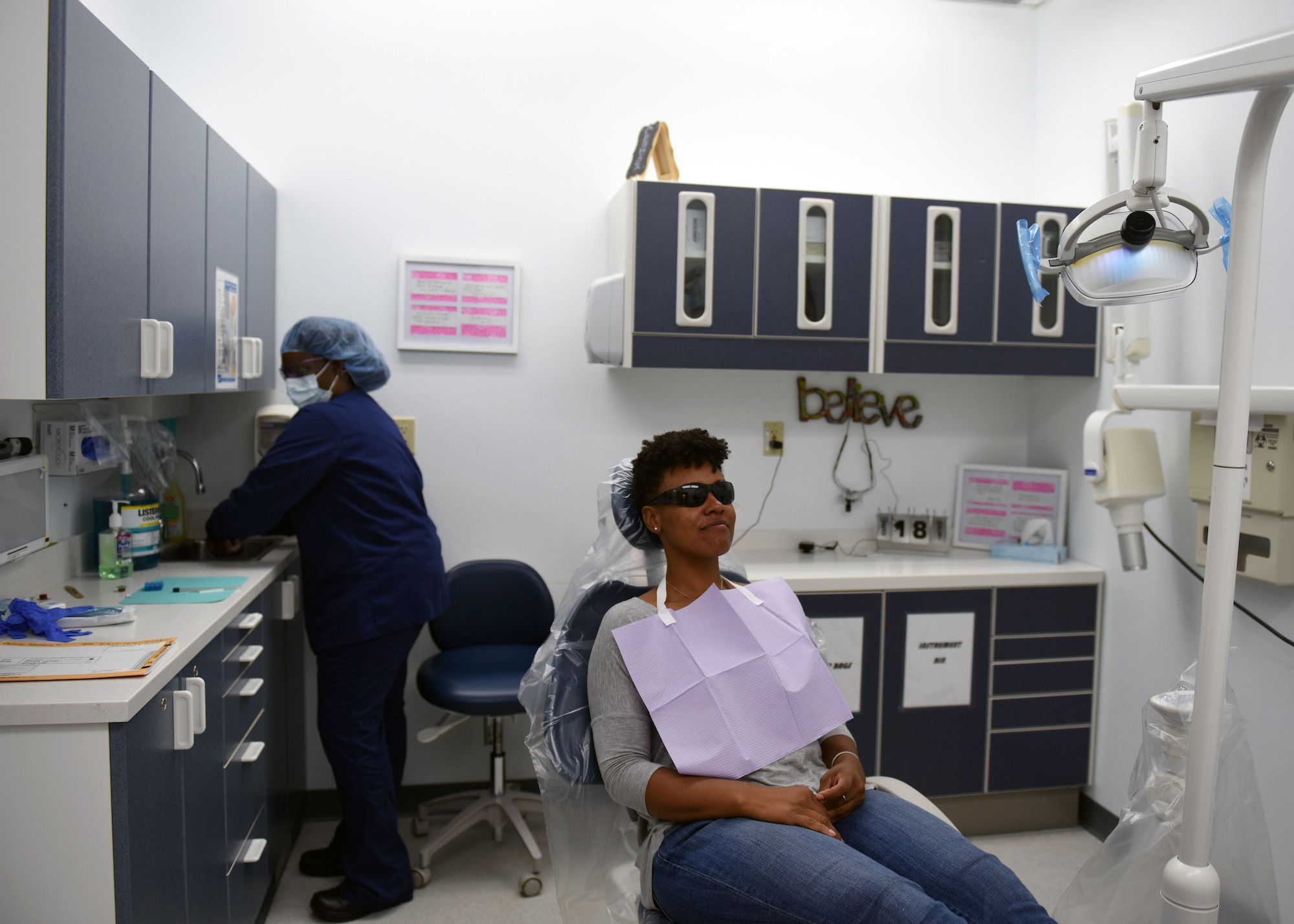 Tech. Sgt. Stephanie Janney, 344th Training Squadron NCOIC of information management, has her teeth cleaned by Aleshiea Johnson, 30th Medical Operations Squadron registered dental assistant, Oct. 18, 2017, Vandenberg Air Force Base, Calif. The dental flight, within the 30th MDOS, is currently celebrating October's National Dental Hygiene Month. The month aims to help raise public awareness on the topic of good oral health and focuses on three main components – brushing teeth daily, flossing, and smart nutrition. (U.S. Air Force photo by Senior Airman Kyla Gifford/Released)